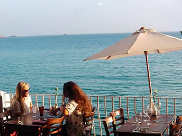 Customers dining on the balcony at Sugareef Restaurant St Brelades Jersey